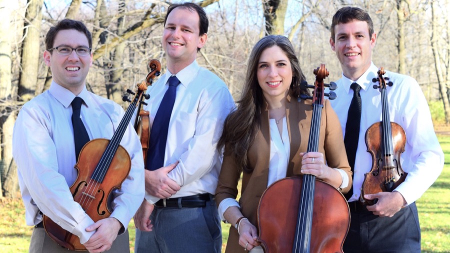 The Kontras Quartet posing outdoors with their string instruments